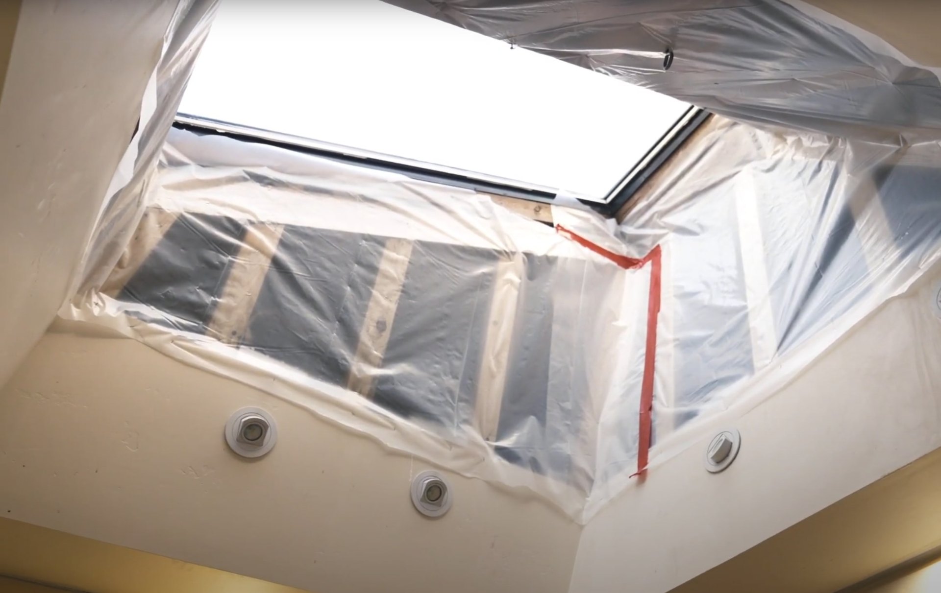 Certified water damage restoration professional following industry safety standards Professional water damage restoration technician working in contained environment with protective equipment